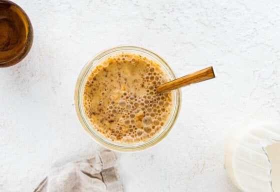 Gingerbread overnight oats mixed up in a mason jar.