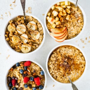 Four bowls of different oatmeal flavor variations: banana nut, apple cinnamon, maple brown sugar and berry almond.