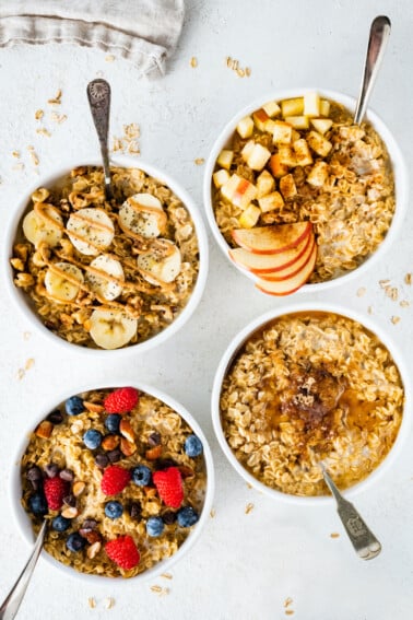 Four bowls of different oatmeal flavor variations: banana nut, apple cinnamon, maple brown sugar and berry almond.