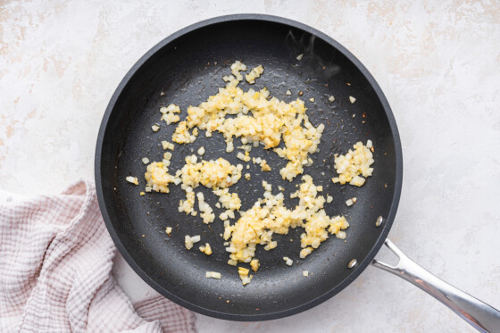 Garlic and ginger sautéing in a skillet.