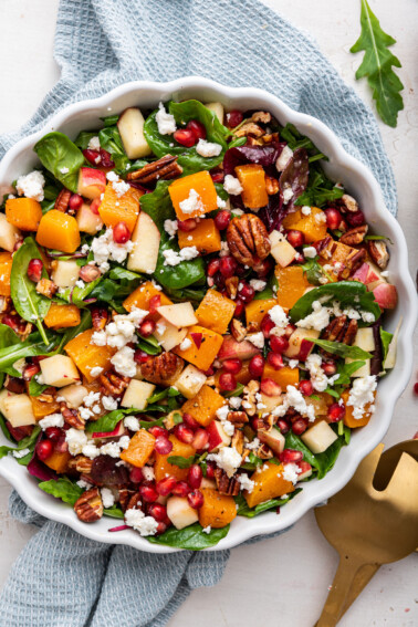 Winter salad being served in a white bowl.