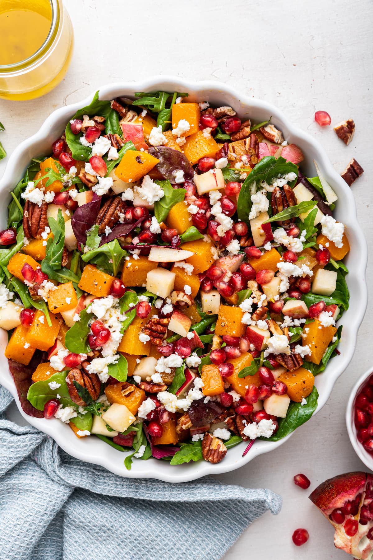 Winter salad being served in a white bowl.