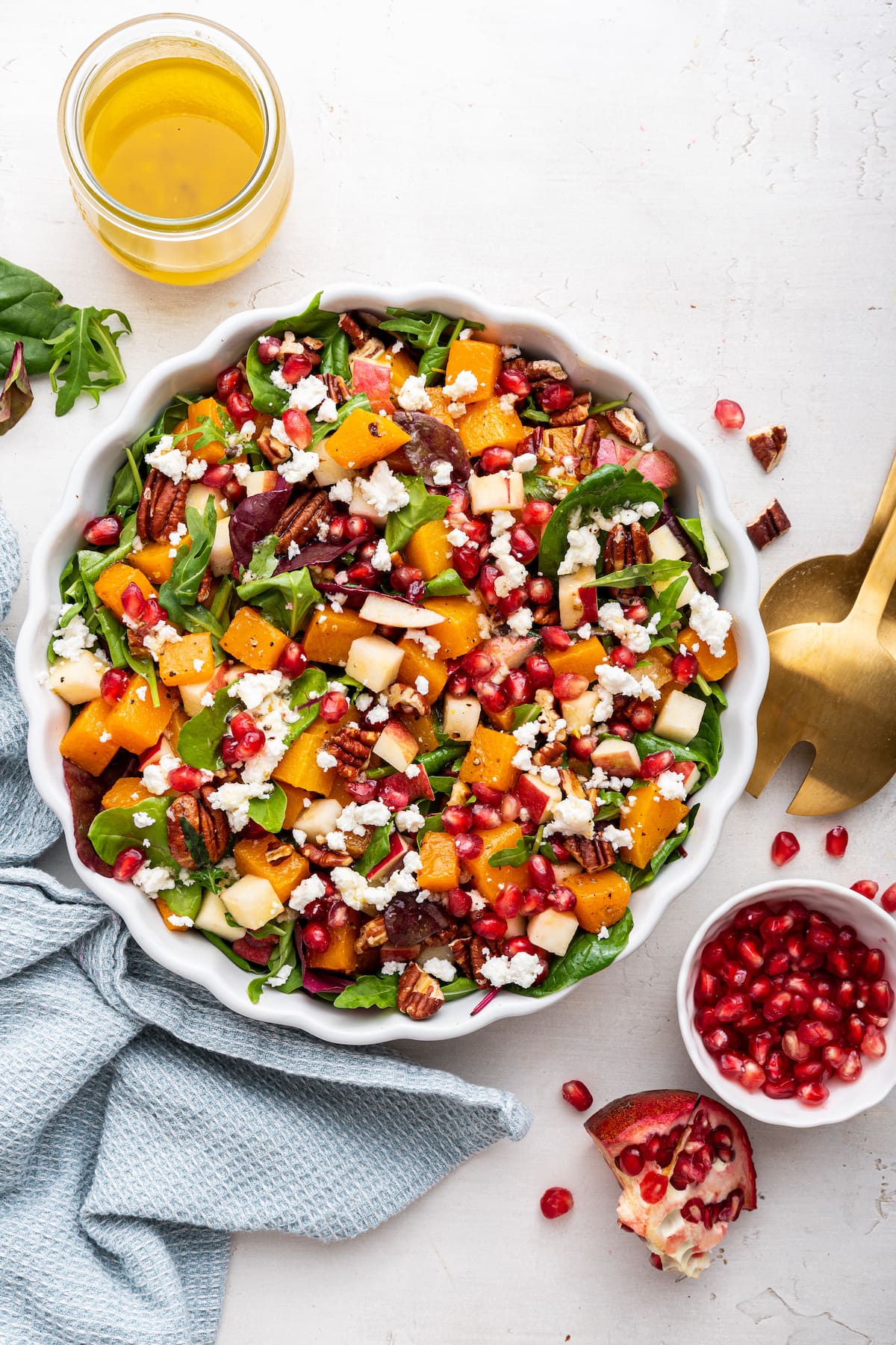 Winter salad being served in a white bowl.