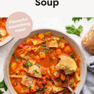 Cabbage Soup in a bowl served with parsley and crusty bread.