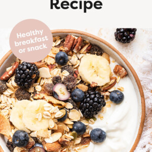 Muesli in a bowl served with fruit and yogurt.