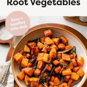 Roasted Root Vegetables in a serving bowl topped with rosemary.
