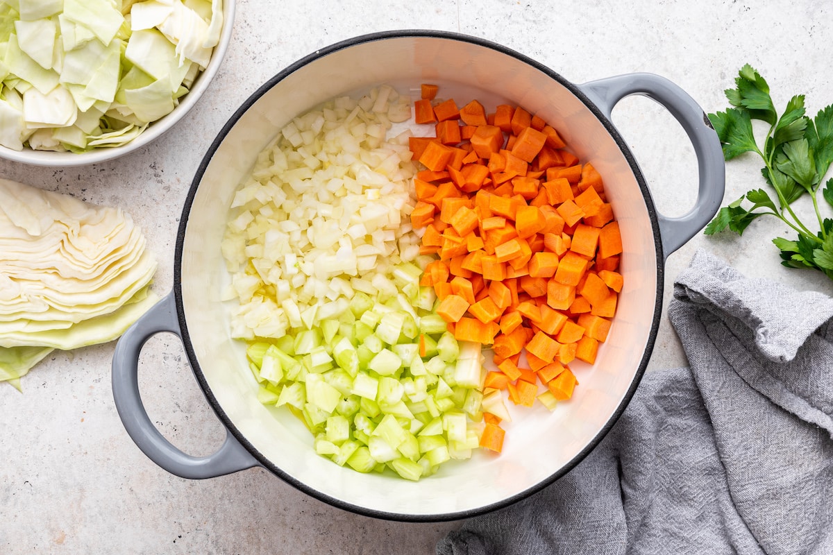Chopped carrots, onion, and celery in a large pot.
