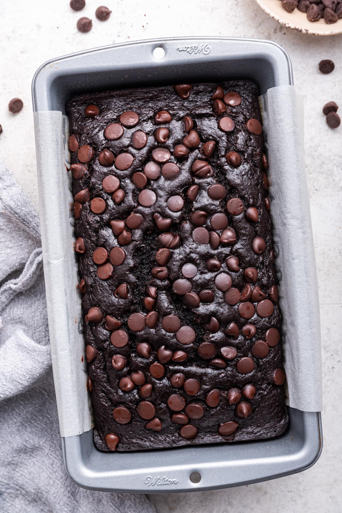 Baked chocolate banana bread loaf in a pan.