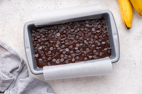 An unbaked loaf of chocolate banana bread in a pan.