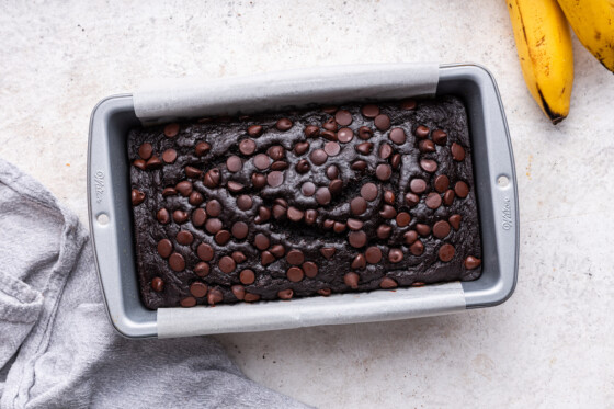 A baked loaf of chocolate banana bread in the pan.