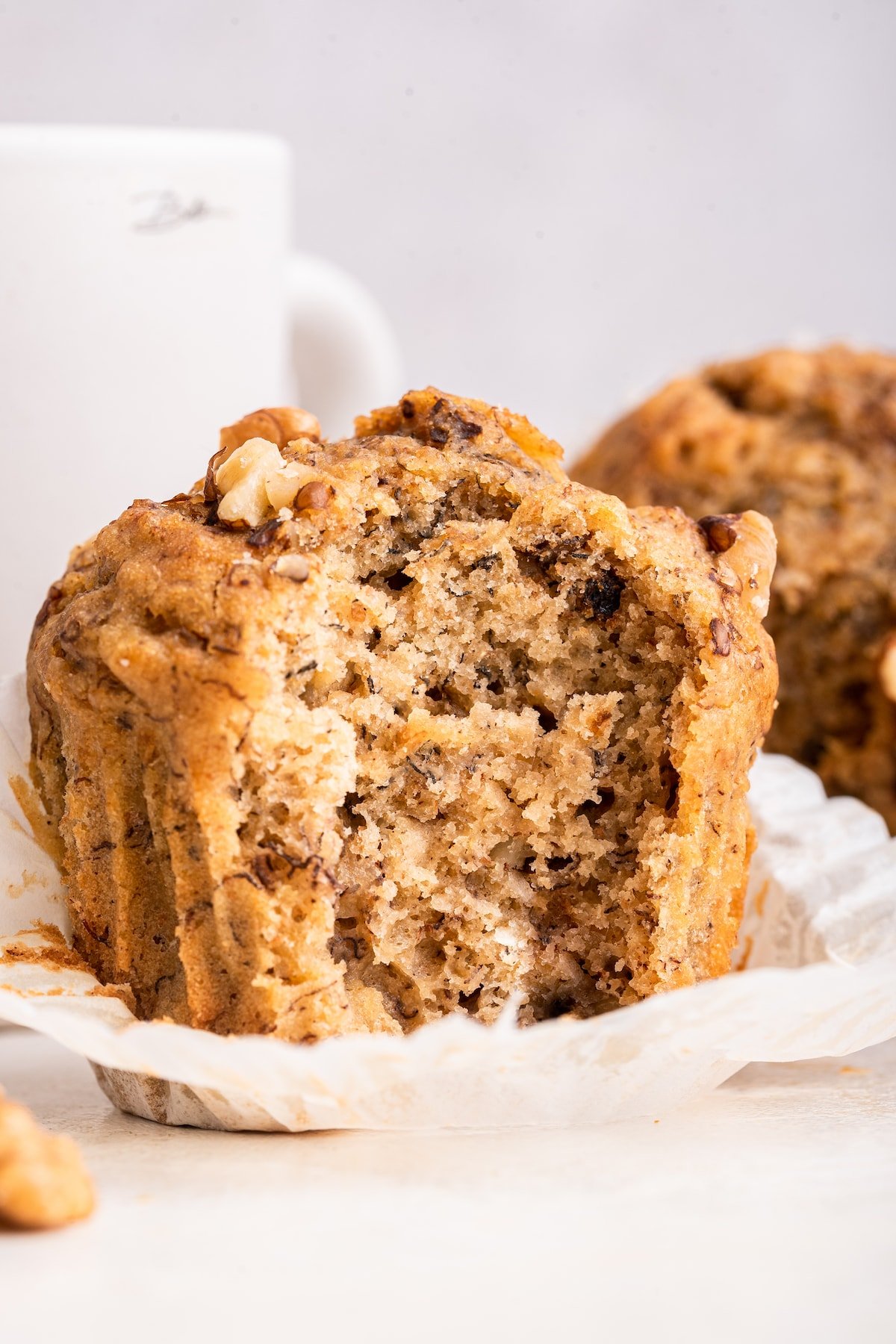 A banana muffin with a bite taken from it.