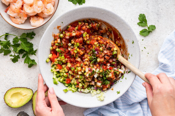 Ingredients for a mexican shrimp cocktail mixed in a bowl.