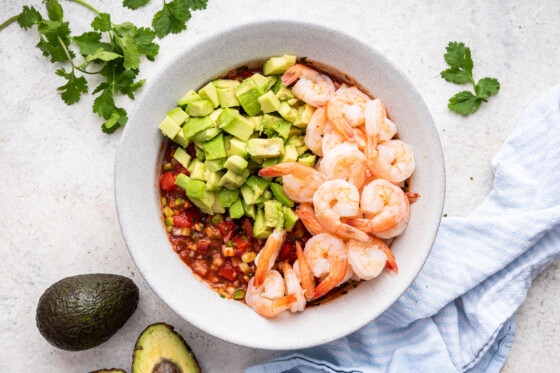 Ingredients for a mexican shrimp cocktail mixed in a bowl.