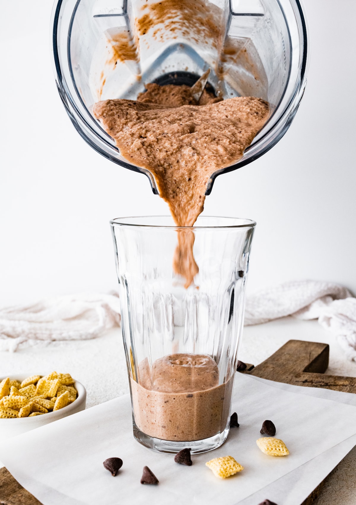 Muddy buddy protein shake being poured into a glass cup from a blender.