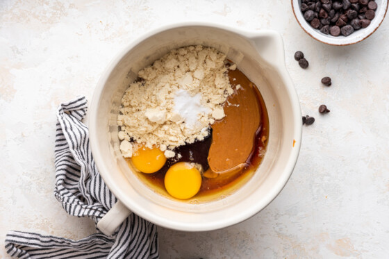 All the ingredients in a large mixing bowl used for the chocolate chip protein cookies before being combined.