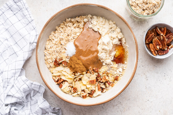 All ingredients used for protein granola in a large mixing bowl before being combined.