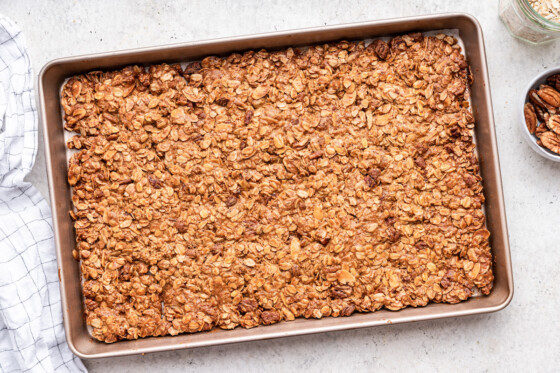 Protein granola on a large baking tray after being baked.