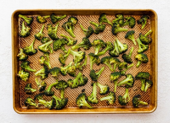 Roasted broccoli on a baking sheet.