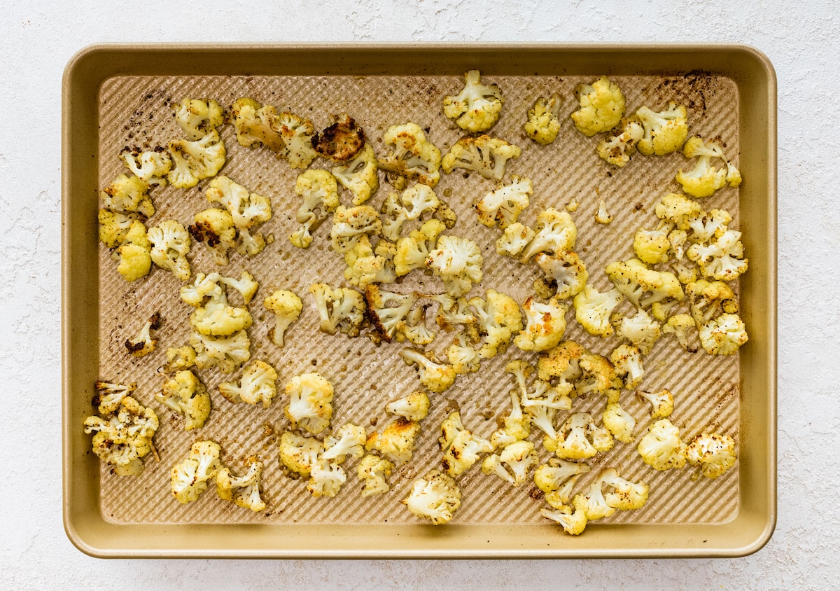 Roasted cauliflower on a baking sheet.