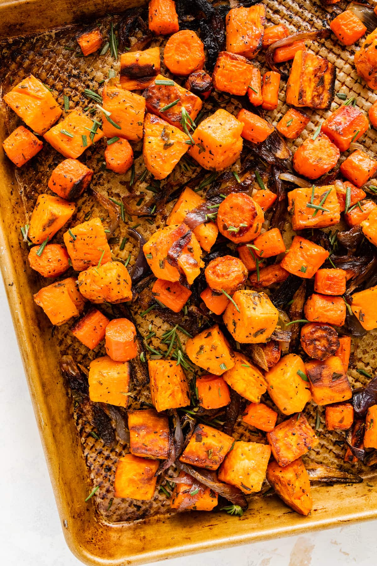 Roasted root vegetables on a baking sheet.