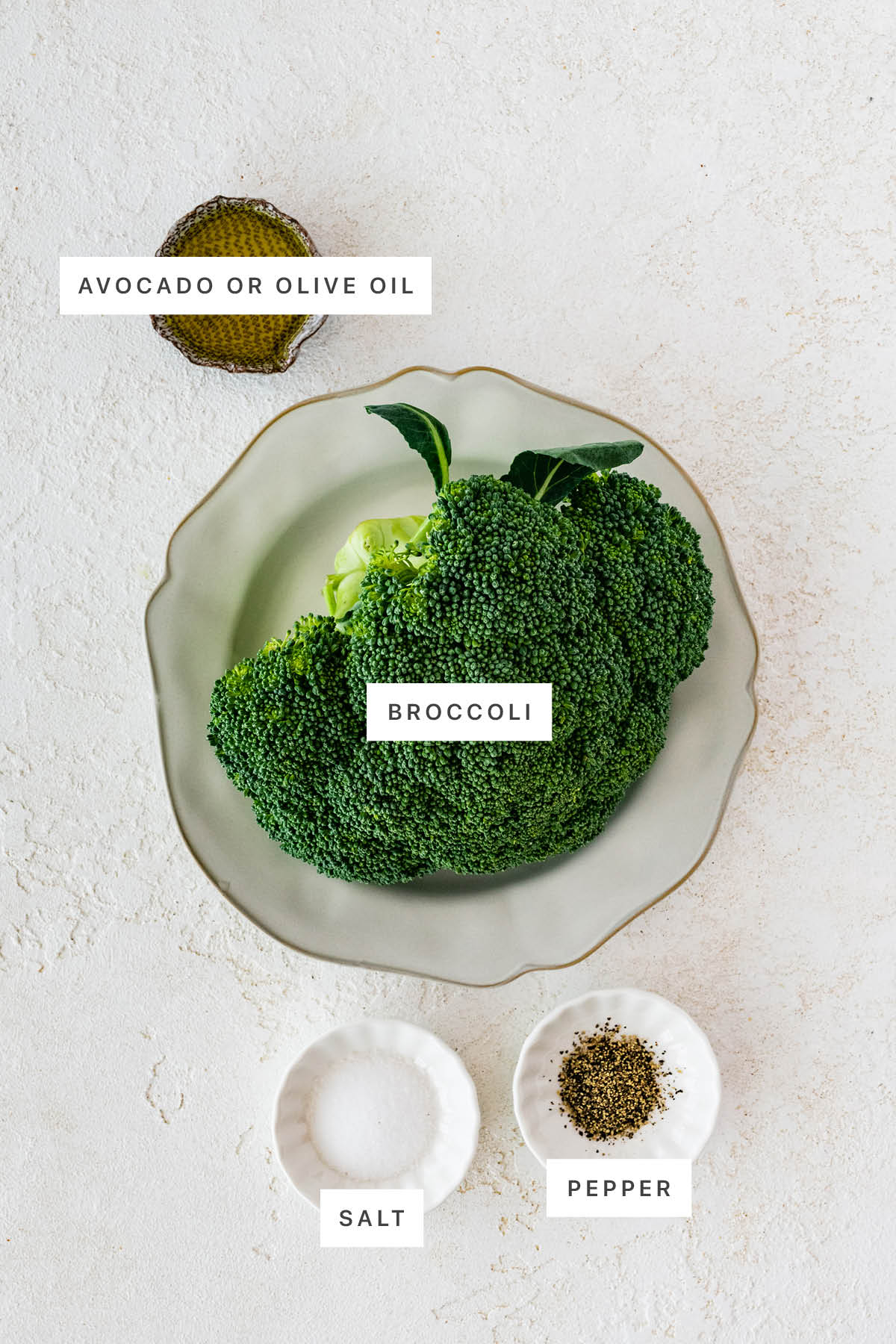 Ingredients measured out to make Roasted Broccoli: olive oil, broccoli, salt and pepper.