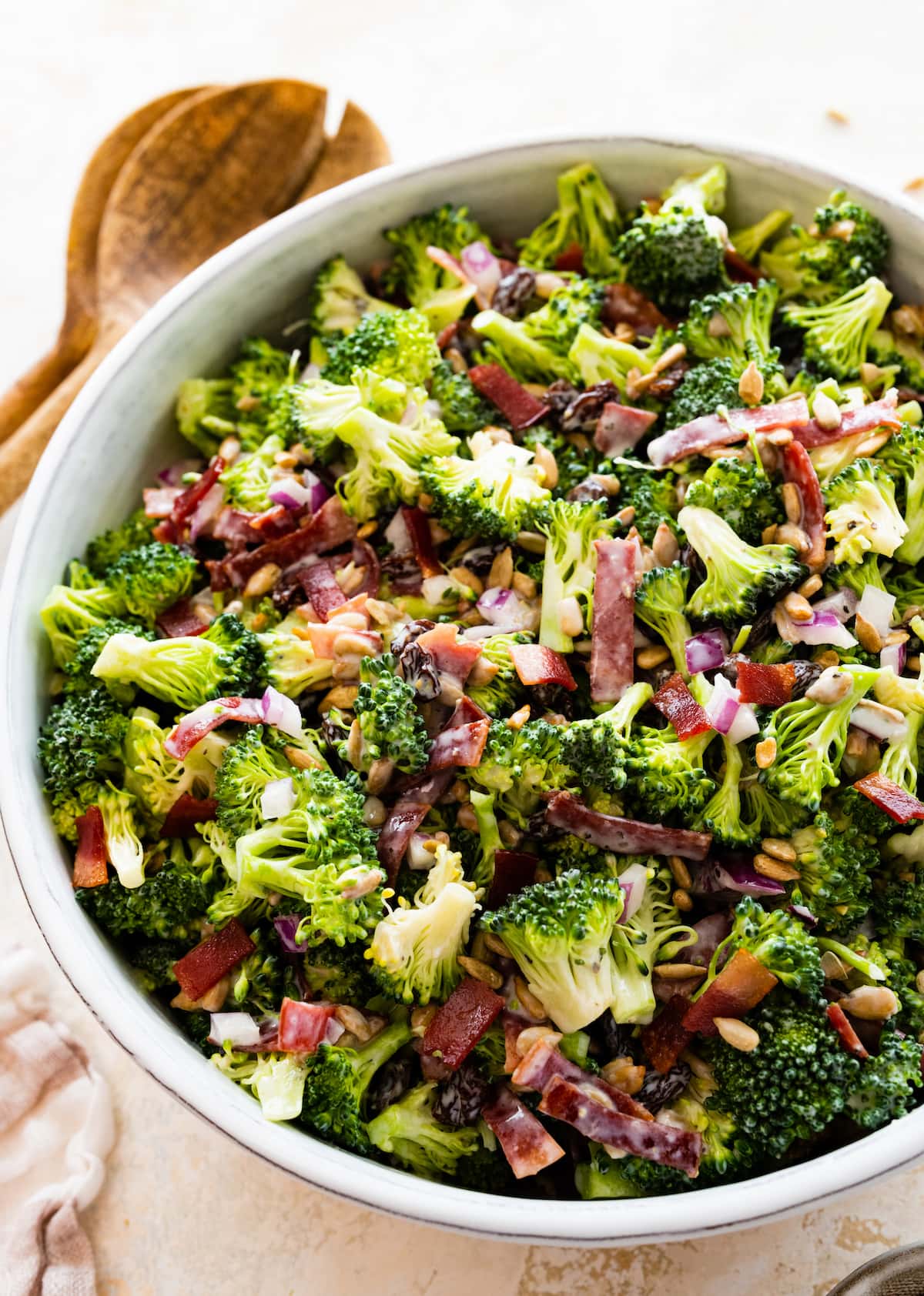 A broccoli salad in a large white bowl.