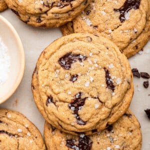 A few brown butter chocolate chip cookies on parchment paper.