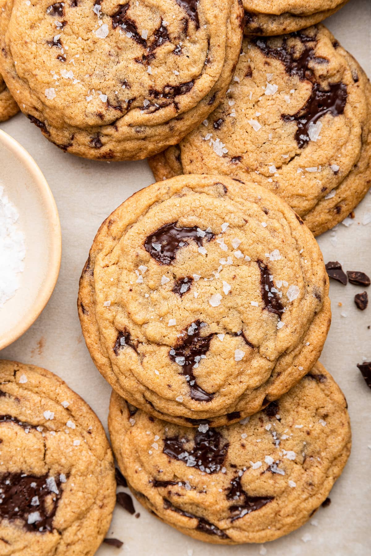 A few brown butter chocolate chip cookies on parchment paper.