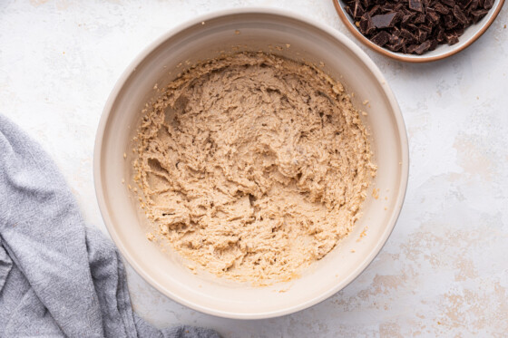 Dough used to make brown butter chocolate chip cookies in a large mixing bowl.