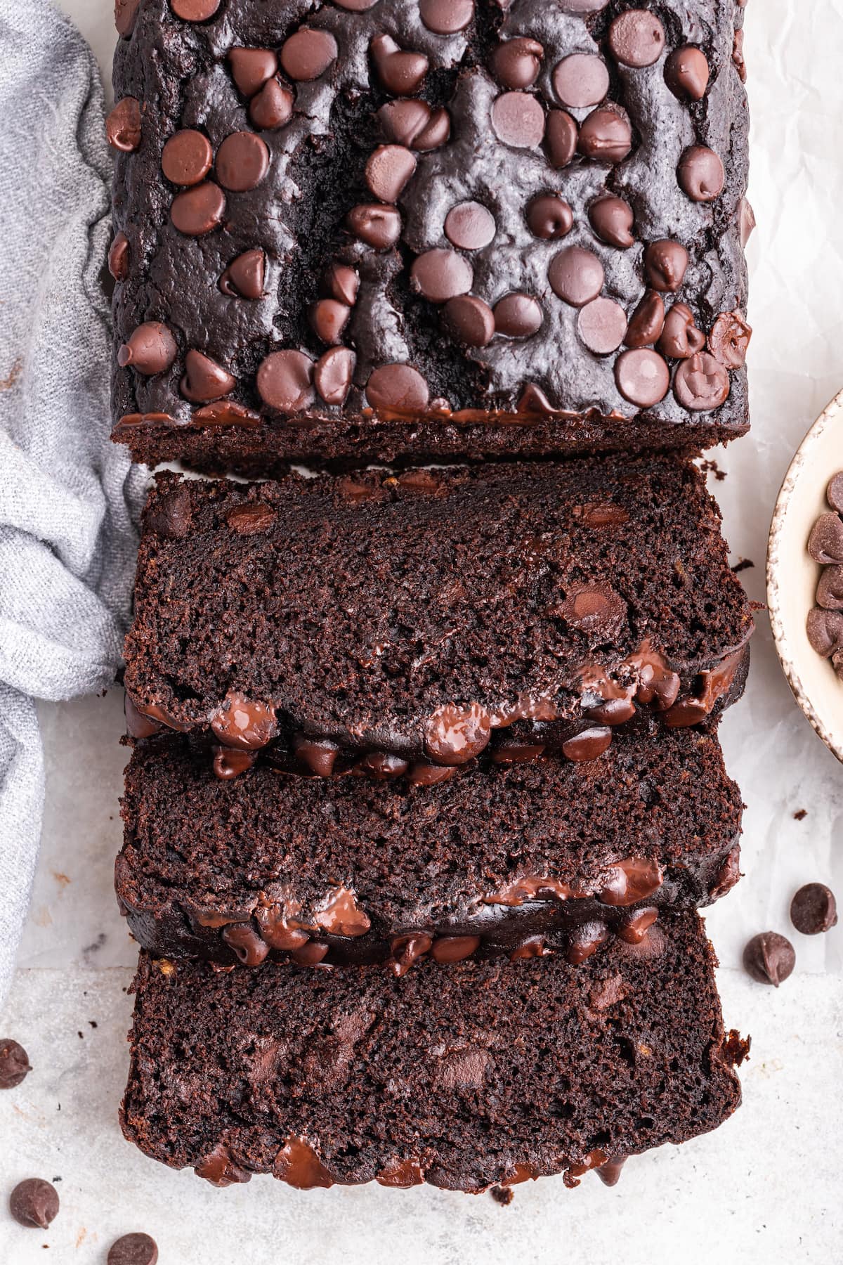 Overhead image of a chocolate banana bread loaf with three slices.