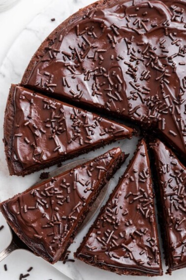 Chocolate protein cake cut into slices on a table.