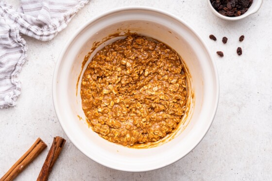 Dough used for oatmeal raisin cookies in a large mixing bowl.