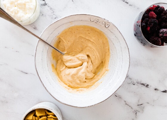 Powdered peanut butter mixed into a bowl of yogurt.