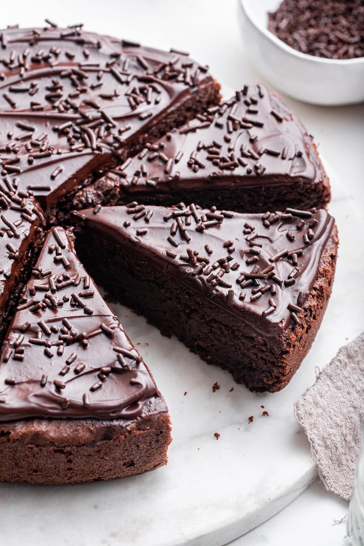 Chocolate protein cake cut into slices on a table.