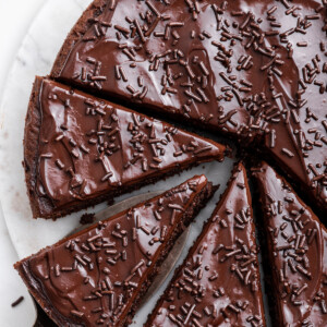 Chocolate protein cake cut into slices on a table.