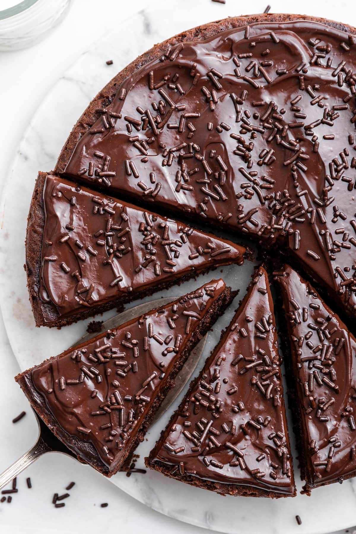 Chocolate protein cake cut into slices on a table.