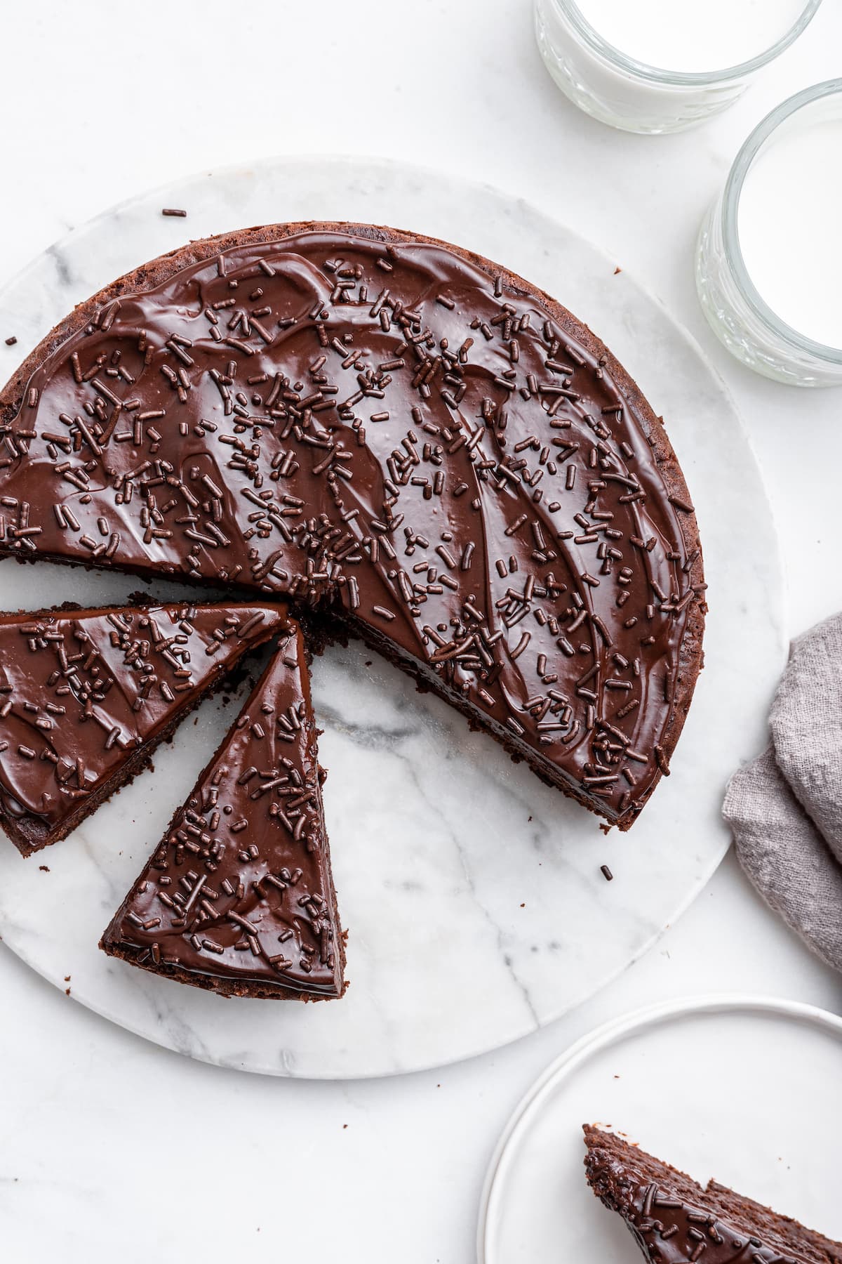 Chocolate protein cake cut into slices on a table.