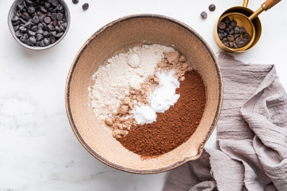 All the dry ingredients used for a protein cake in a large mixing bowl.