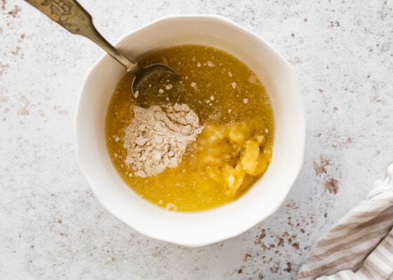 All ingredients used for a protein pancake in a mixing bowl with a spoon.