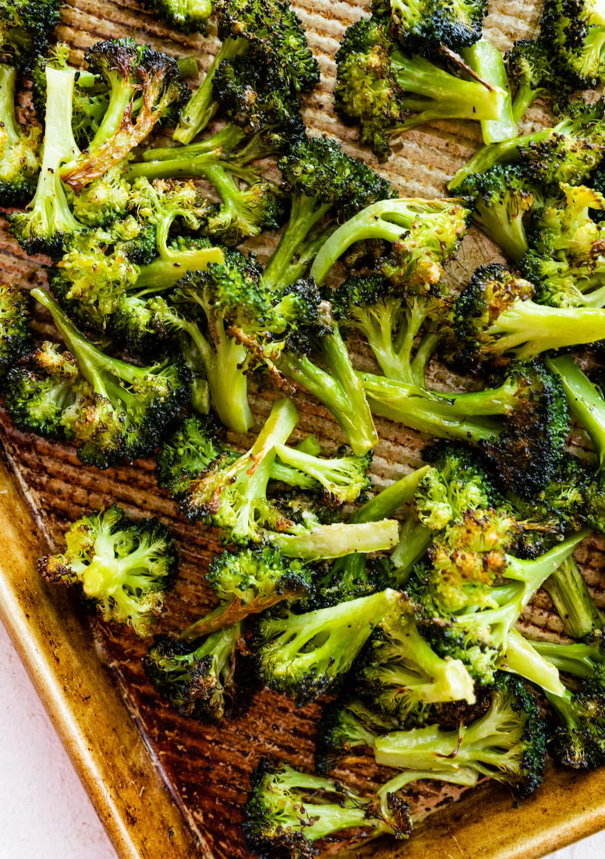 Roasted broccoli on a baking sheet.