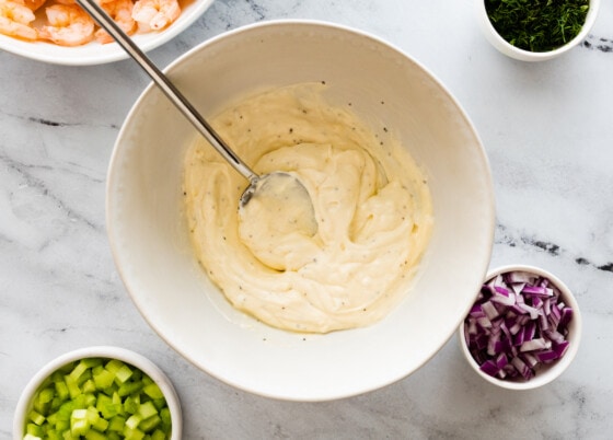 Dressing for the shrimp salad mixed together in a white bowl.