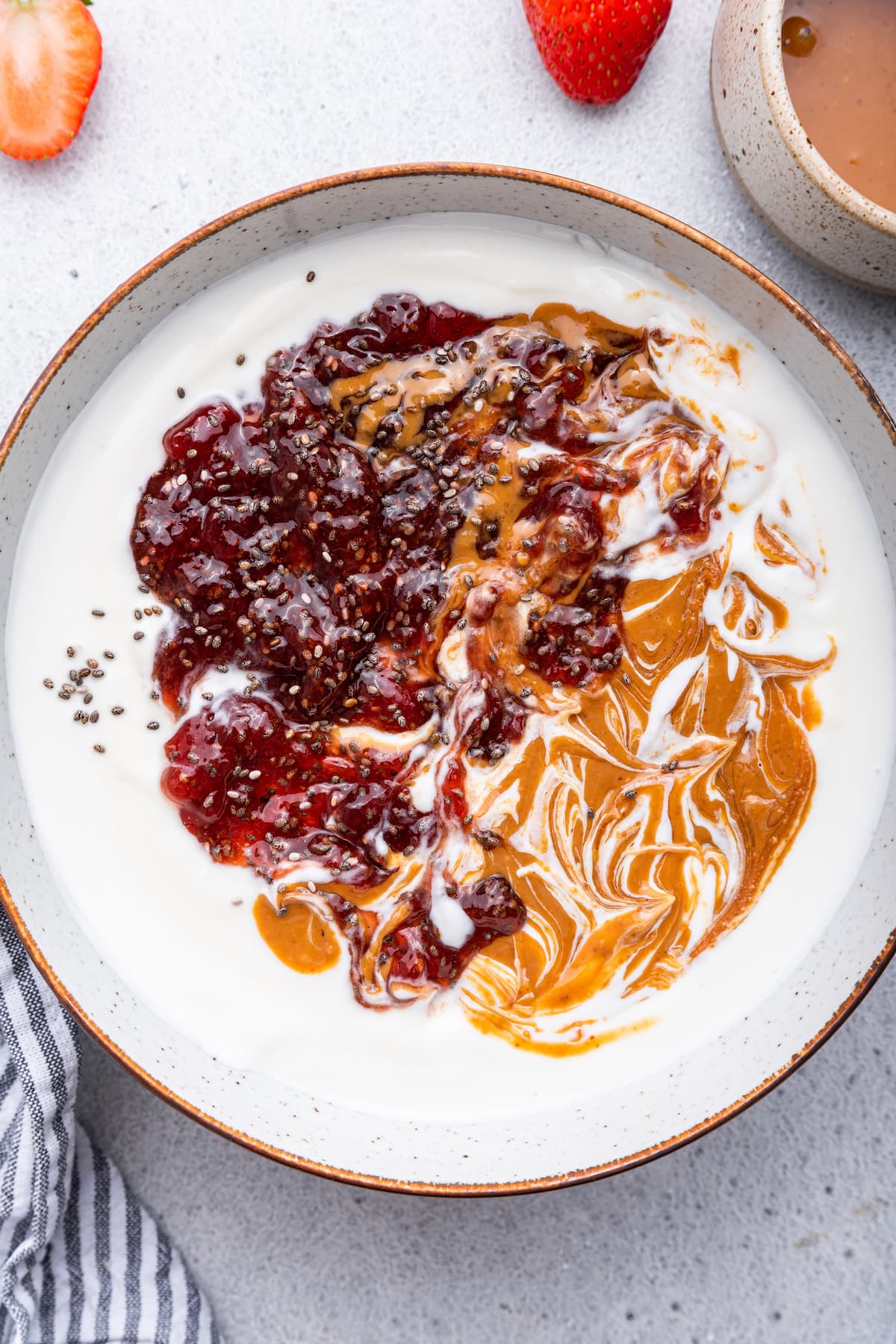 A yogurt bowl topped with peanut butter and jelly.