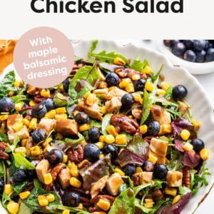 Salad topped with pecans, blueberries, chopped grilled chicken, corn and maple balsamic dressing.