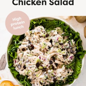 Tarragon Chicken Salad served over a bowl of lettuce with crackers on the side.