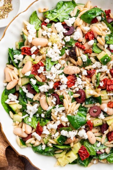 A large bowl of mediterranean orzo salad.