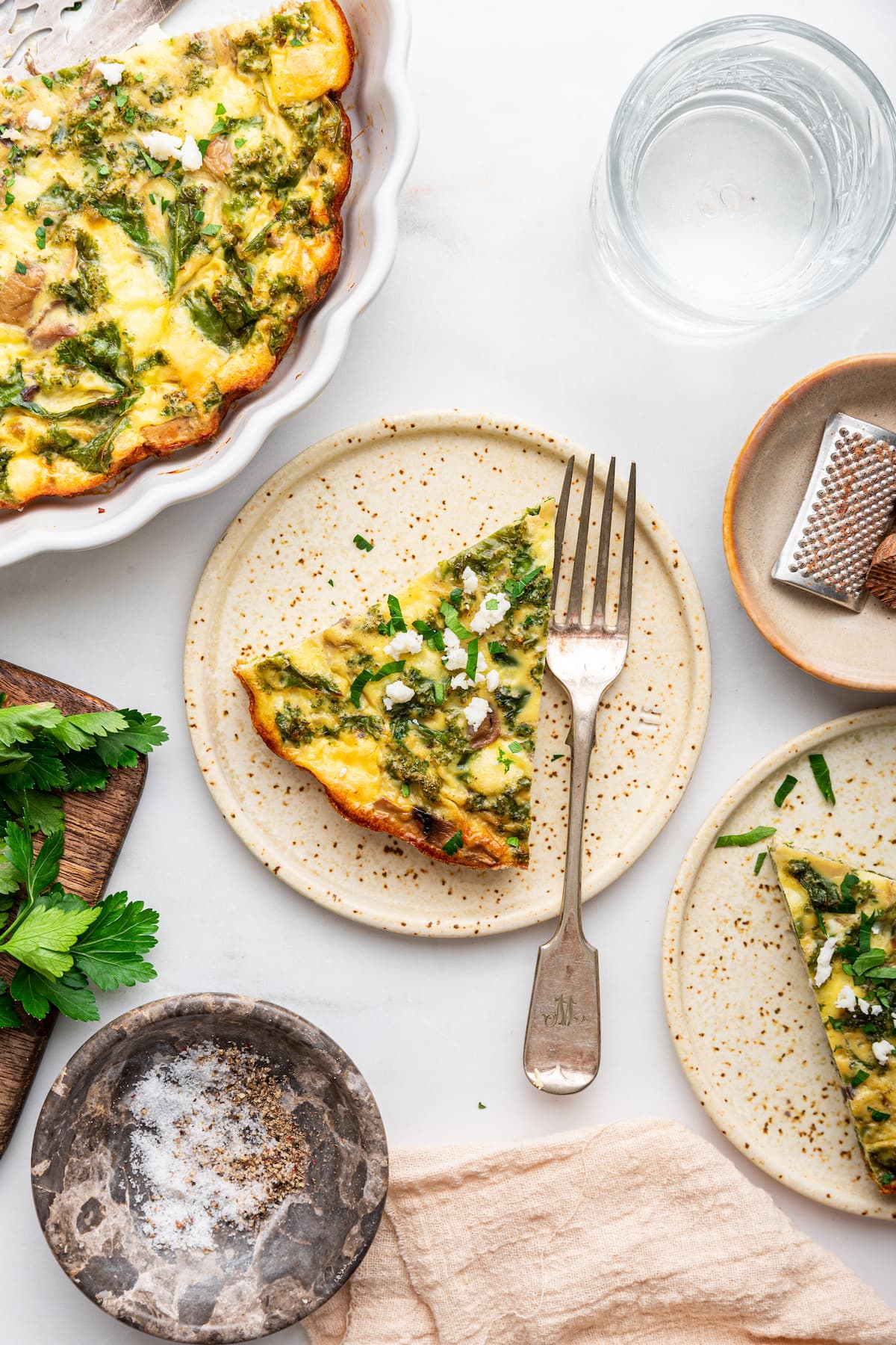 A slice of the crustless quiche on a plate with a fork.