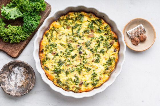 An uncut crustless quiche in a pie plate.