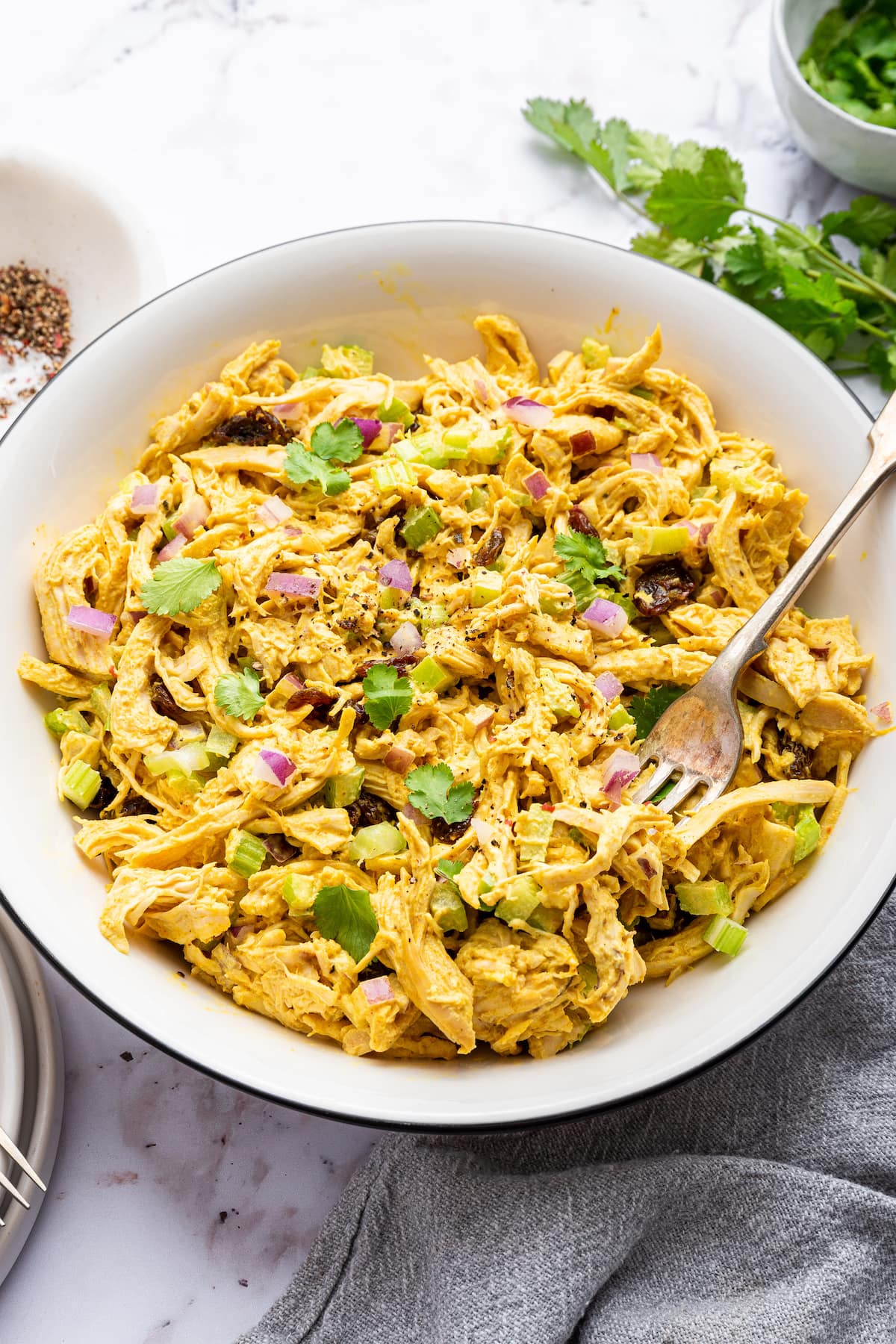 Curry chicken salad in a white bowl.