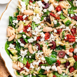 A large bowl of mediterranean orzo salad.