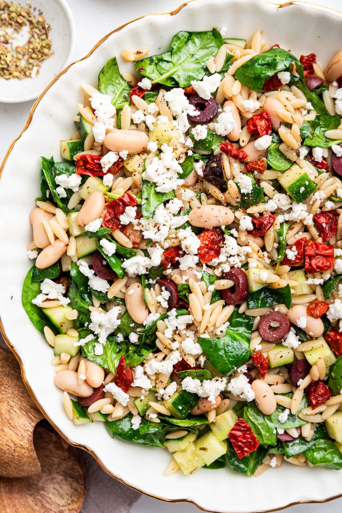 A large bowl of mediterranean orzo salad.